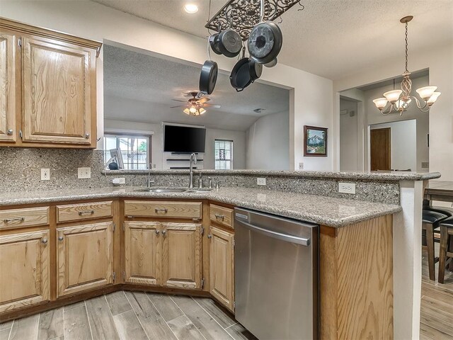 1813 Richard Dr, Edmond, OK 73003 - kitchen with stainless steel dishwasher, a sink, a chandelier, ceiling fan, and light wood-style flooring