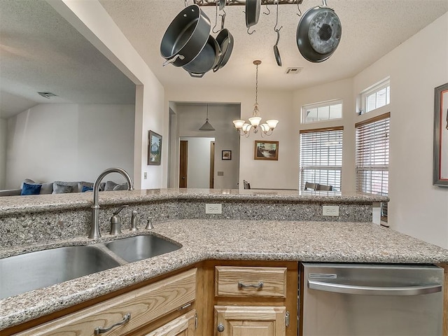 1813 Richard Dr, Edmond, OK 73003 - kitchen with dishwasher, a sink, a chandelier, light stone countertops, and a textured ceiling