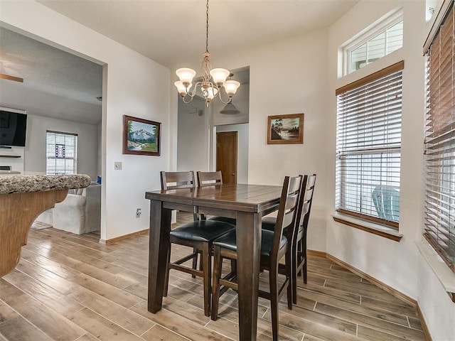 1813 Richard Dr, Edmond, OK 73003 - dining area with light wood finished floors, a chandelier, and baseboards