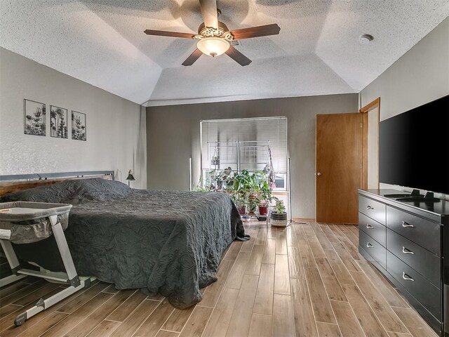 1813 Richard Dr, Edmond, OK 73003 - bedroom with lofted ceiling, light wood-type flooring, a textured ceiling, and ceiling fan