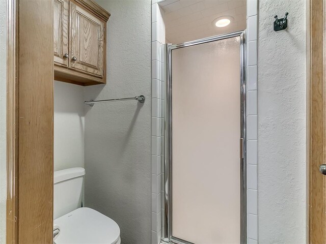 1813 Richard Dr, Edmond, OK 73003 - full bath with a textured wall, a shower stall, and toilet