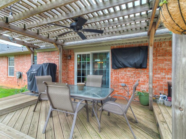 1813 Richard Dr, Edmond, OK 73003 - wooden terrace featuring a pergola, outdoor dining area, and ceiling fan