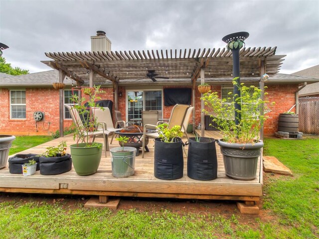 1813 Richard Dr, Edmond, OK 73003 - wooden deck featuring ceiling fan, a pergola, an outdoor fire pit, and a yard