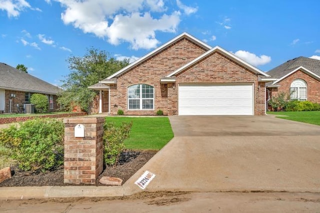 3224 Peacock Ln, Altus, OK 73521 - single story home with an attached garage, concrete driveway, brick siding, and a front yard