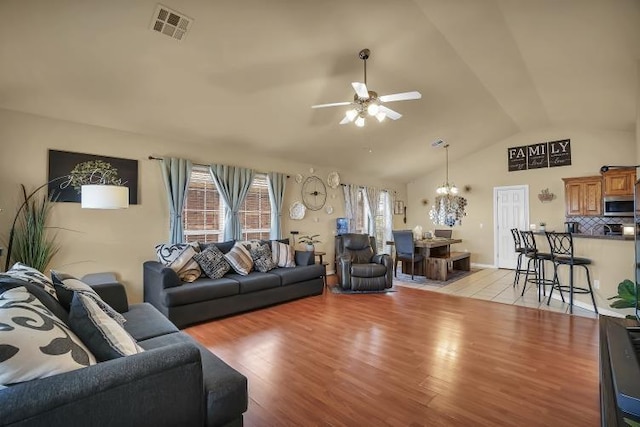 3224 Peacock Ln, Altus, OK 73521 - living room with a ceiling fan, a chandelier, lofted ceiling, and light wood finished floors