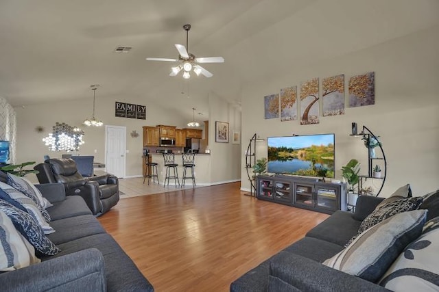 3224 Peacock Ln, Altus, OK 73521 - living area featuring ceiling fan, a chandelier, light wood-style flooring, high vaulted ceiling, and baseboards
