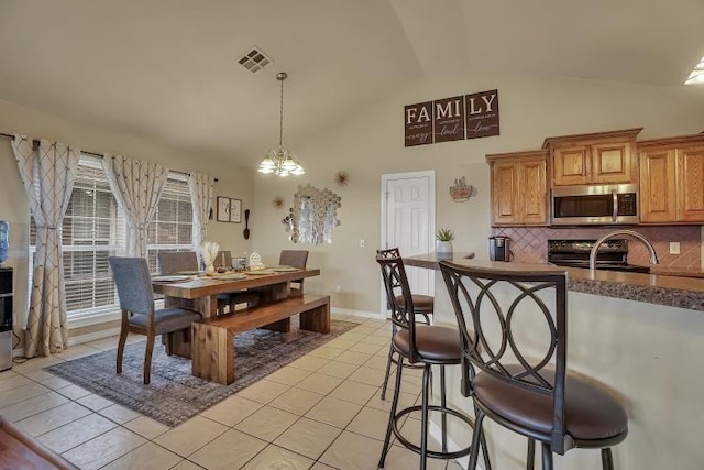 3224 Peacock Ln, Altus, OK 73521 - dining space featuring high vaulted ceiling, a chandelier, and light tile patterned floors