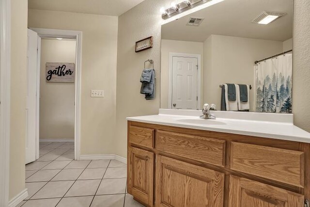 3224 Peacock Ln, Altus, OK 73521 - full bathroom featuring vanity, tile patterned floors, and baseboards