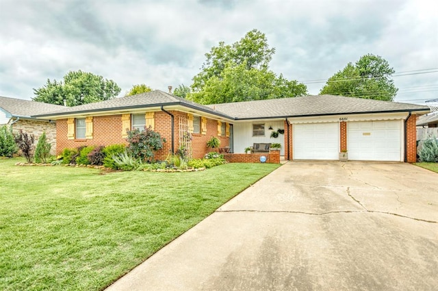 6601 N Ann Arbor Ter, Oklahoma City, OK 73132 - ranch-style house with a garage, brick siding, concrete driveway, and a front lawn
