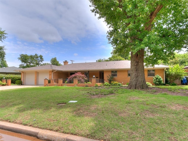 203 N Sherry Ave, Norman, OK 73069 - single story home featuring a garage, a chimney, brick siding, a front lawn, and driveway