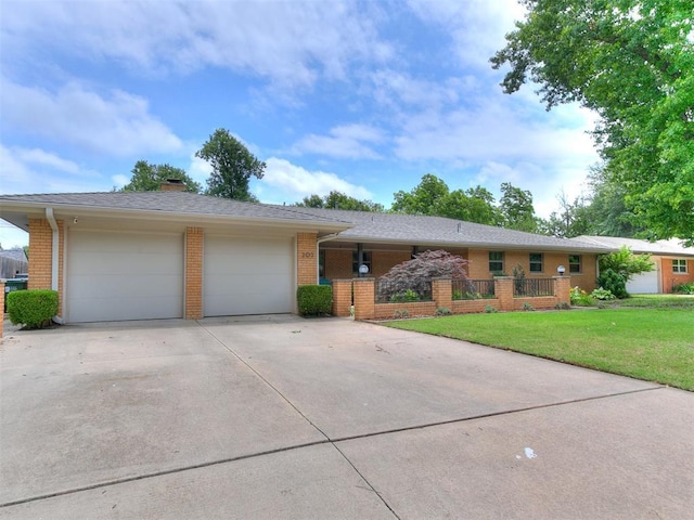 203 N Sherry Ave, Norman, OK 73069 - single story home featuring brick siding, driveway, a garage, a front yard, and a chimney
