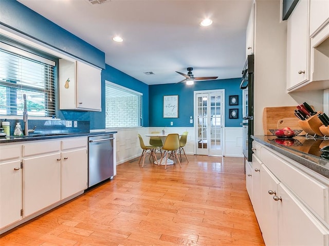 203 N Sherry Ave, Norman, OK 73069 - kitchen with black appliances, dark countertops, french doors, a wainscoted wall, and ceiling fan