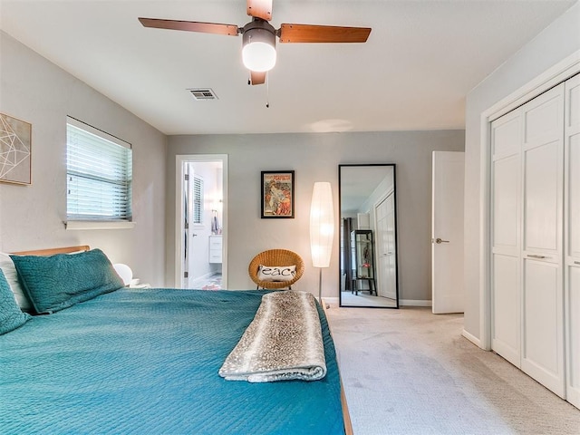 203 N Sherry Ave, Norman, OK 73069 - bedroom featuring light colored carpet, a closet, ceiling fan, ensuite bath, and baseboards