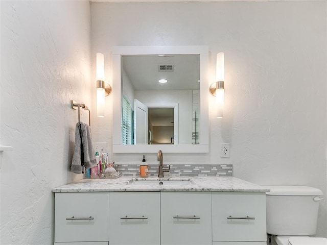 203 N Sherry Ave, Norman, OK 73069 - bathroom with vanity, toilet, and a textured wall