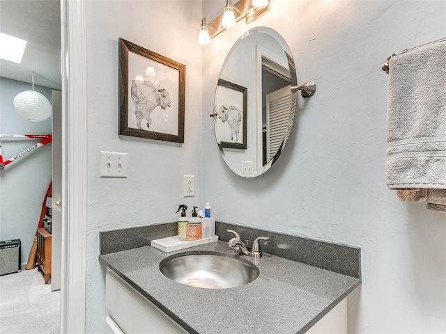 203 N Sherry Ave, Norman, OK 73069 - bathroom with vanity and a skylight