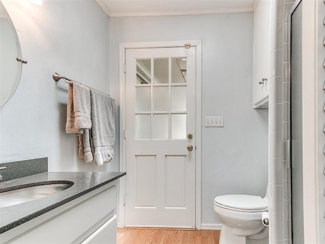 203 N Sherry Ave, Norman, OK 73069 - bathroom with vanity, wood finished floors, crown molding, toilet, and a shower with door