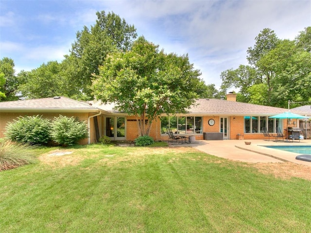 203 N Sherry Ave, Norman, OK 73069 - back of property with brick siding, a yard, and french doors