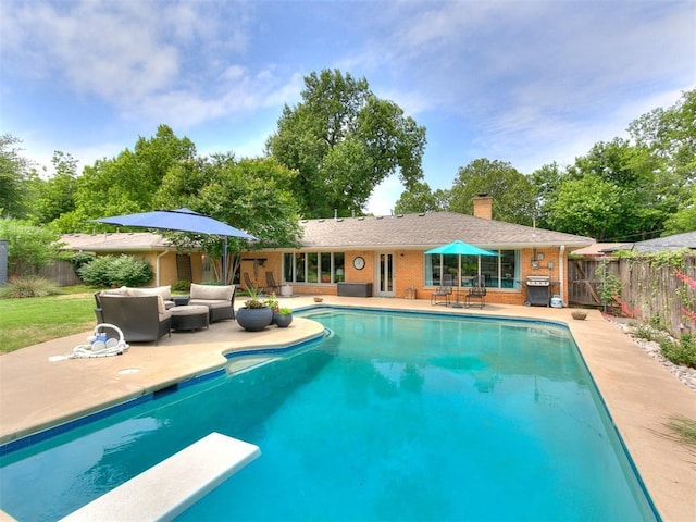 203 N Sherry Ave, Norman, OK 73069 - view of pool with a patio, a fenced backyard, a diving board, an outdoor living space, and grilling area