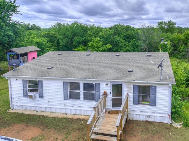 14417 Longhorn Dr, Jones, OK 73049 - view of front facade featuring a shingled roof, cooling unit, and a wooded view