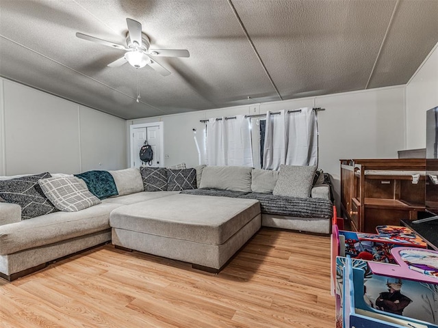 14417 Longhorn Dr, Jones, OK 73049 - living room featuring light wood-style floors, a ceiling fan, a textured ceiling, and lofted ceiling