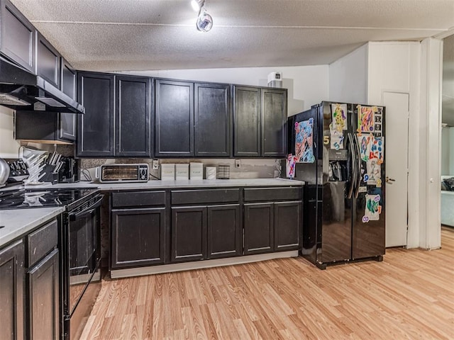 14417 Longhorn Dr, Jones, OK 73049 - kitchen with black appliances, light wood-style flooring, range hood, and light countertops