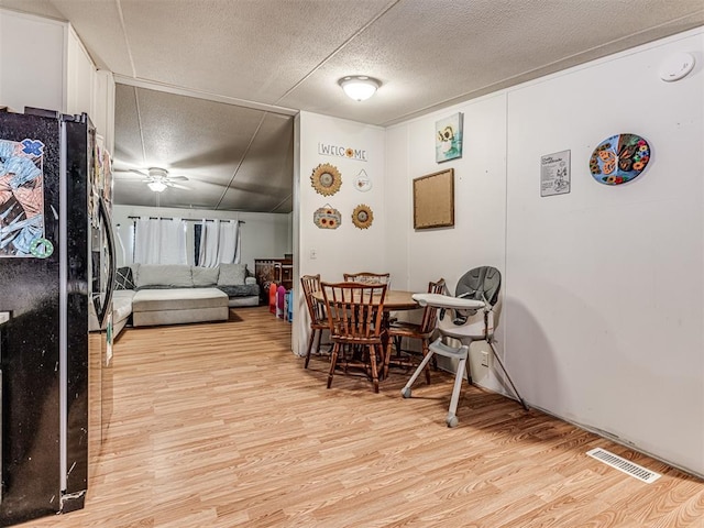 14417 Longhorn Dr, Jones, OK 73049 - dining room with a textured ceiling, light wood finished floors, and a ceiling fan