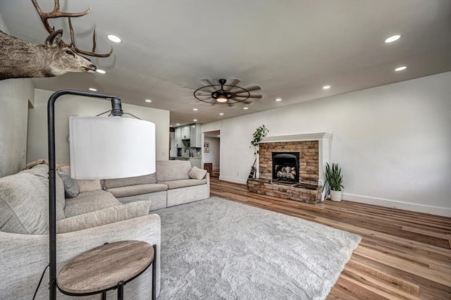 2401 Davis Rd, Guthrie, OK 73044 - living room with wood finished floors, baseboards, recessed lighting, a ceiling fan, and a fireplace
