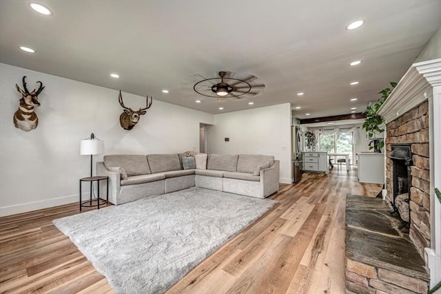 2401 Davis Rd, Guthrie, OK 73044 - living room featuring light wood-type flooring, a fireplace, recessed lighting, and baseboards