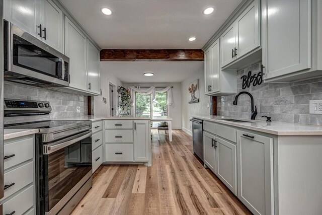 2401 Davis Rd, Guthrie, OK 73044 - kitchen featuring stainless steel appliances, a sink, light countertops, recessed lighting, and light wood-style flooring