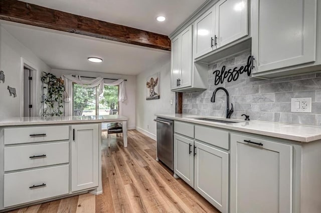 2401 Davis Rd, Guthrie, OK 73044 - kitchen with stainless steel dishwasher, a sink, light countertops, beam ceiling, and light wood-style floors