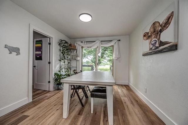 2401 Davis Rd, Guthrie, OK 73044 - dining room featuring light wood finished floors, baseboards, and a textured wall