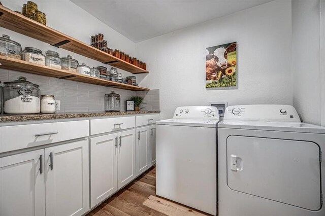 2401 Davis Rd, Guthrie, OK 73044 - laundry room featuring independent washer and dryer, wood finished floors, and cabinet space