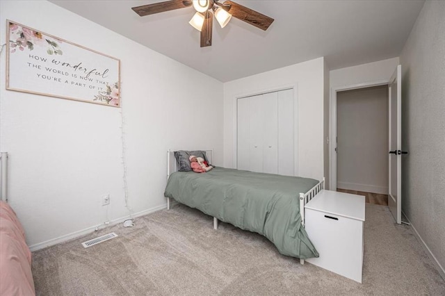 2401 Davis Rd, Guthrie, OK 73044 - bedroom with light carpet, a ceiling fan, and a closet