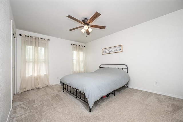 2401 Davis Rd, Guthrie, OK 73044 - carpeted bedroom with baseboards and a ceiling fan