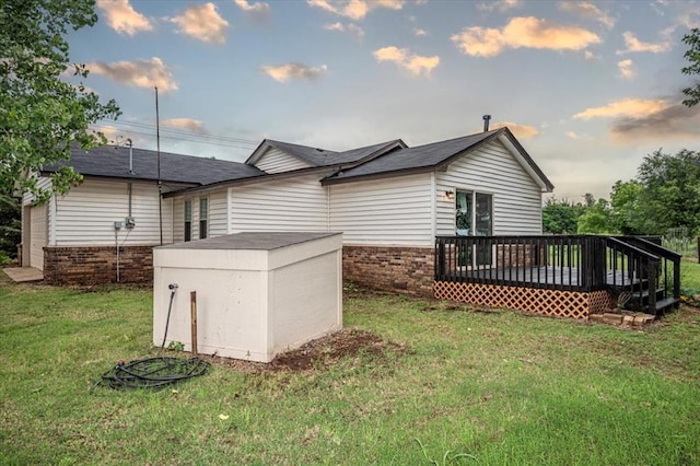 2401 Davis Rd, Guthrie, OK 73044 - rear view of property featuring brick siding, a wooden deck, and a yard