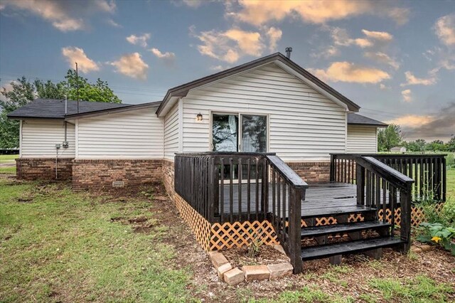 2401 Davis Rd, Guthrie, OK 73044 - back of house with a wooden deck, a yard, and brick siding