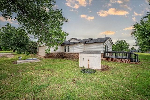 2401 Davis Rd, Guthrie, OK 73044 - property exterior at dusk with a wooden deck, a lawn, and an attached garage