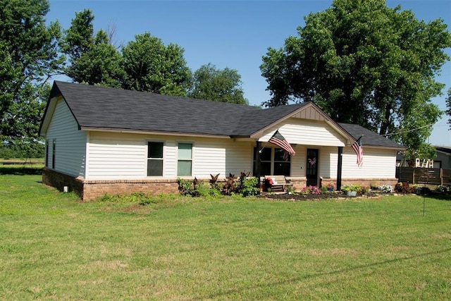 2401 Davis Rd, Guthrie, OK 73044 - view of front of house featuring a front lawn, covered porch, brick siding, and a shingled roof