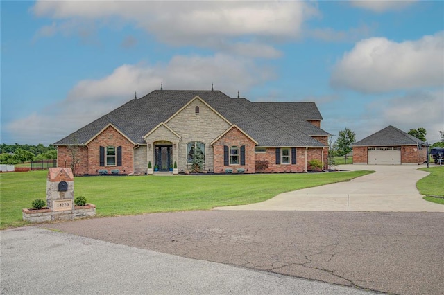 14220 SE 76th Pl, Oklahoma City, OK 73150 - french country inspired facade with roof with shingles, driveway, and brick siding