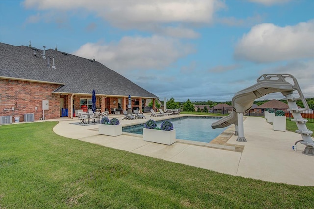 14220 SE 76th Pl, Oklahoma City, OK 73150 - view of swimming pool featuring a water slide, a patio area, a yard, and central AC unit