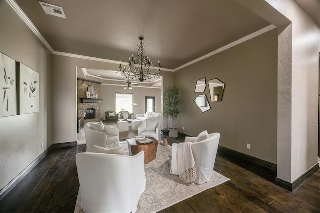 15101 Colonia Bella Dr, Edmond, OK 73013 - living room with a chandelier, ornamental molding, dark wood-style flooring, baseboards, and a fireplace