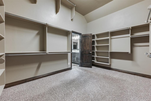 15101 Colonia Bella Dr, Edmond, OK 73013 - spacious closet featuring vaulted ceiling and carpet flooring