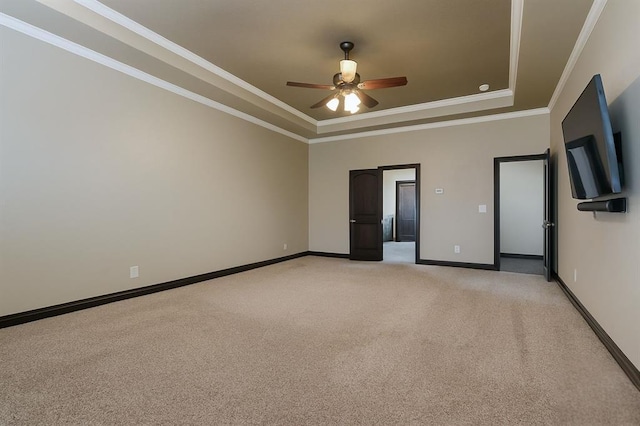 15101 Colonia Bella Dr, Edmond, OK 73013 - spare room featuring a raised ceiling, a ceiling fan, baseboards, light colored carpet, and ornamental molding