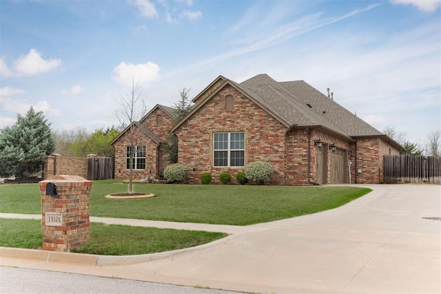 15101 Colonia Bella Dr, Edmond, OK 73013 - view of front of house with driveway, brick siding, a shingled roof, and a garage