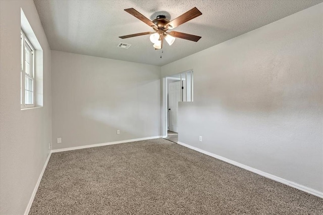 1013 Locust Ln, Midwest City, OK 73110 - carpeted spare room with ceiling fan, baseboards, and a textured ceiling