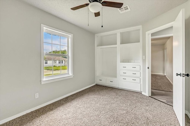 1013 Locust Ln, Midwest City, OK 73110 - unfurnished bedroom featuring carpet floors, baseboards, a textured ceiling, and ceiling fan