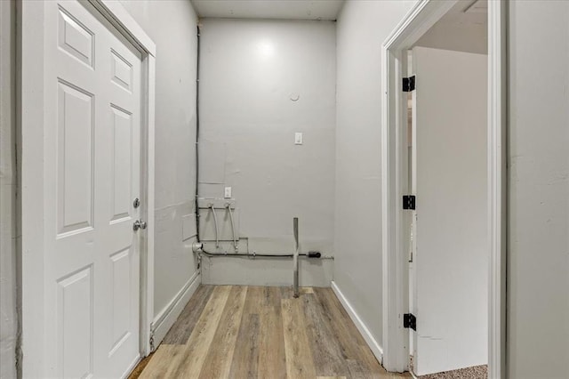 1013 Locust Ln, Midwest City, OK 73110 - laundry room featuring light wood-style floors and baseboards