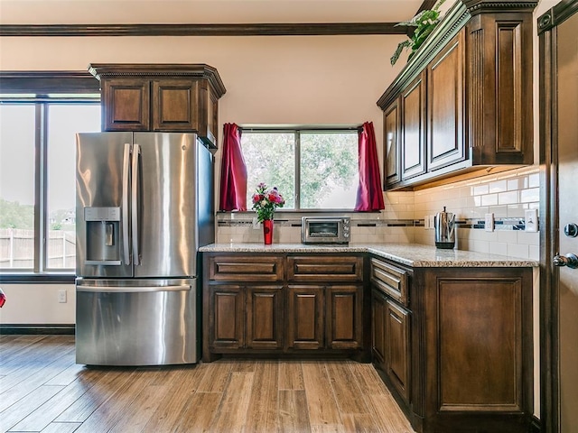 3424 Lakeside Dr, Moore, OK 73160 - kitchen with stainless steel refrigerator with ice dispenser, tasteful backsplash, plenty of natural light, and ornamental molding