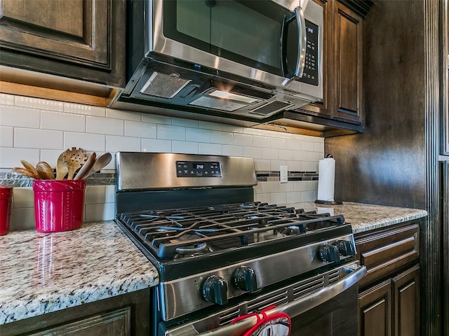 3424 Lakeside Dr, Moore, OK 73160 - kitchen featuring appliances with stainless steel finishes, dark brown cabinetry, and tasteful backsplash