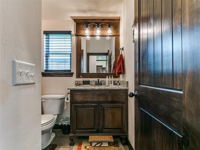 3424 Lakeside Dr, Moore, OK 73160 - bathroom featuring vanity, toilet, and wood finished floors